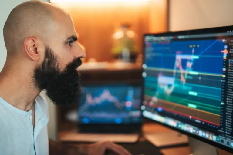 Crypto user managing digital assets through wallet and trading interface on laptop
